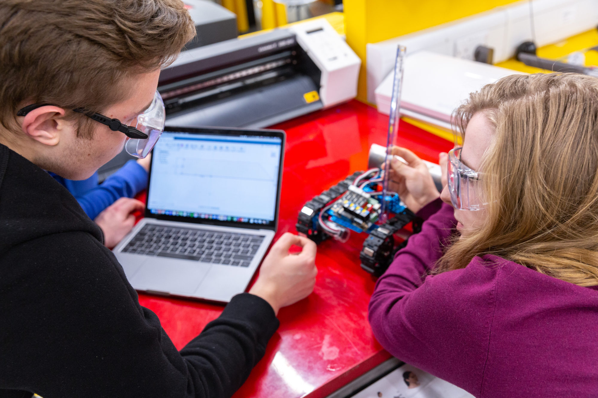 Students work together at a computer