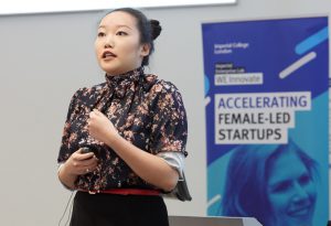 Woman presenting on stage